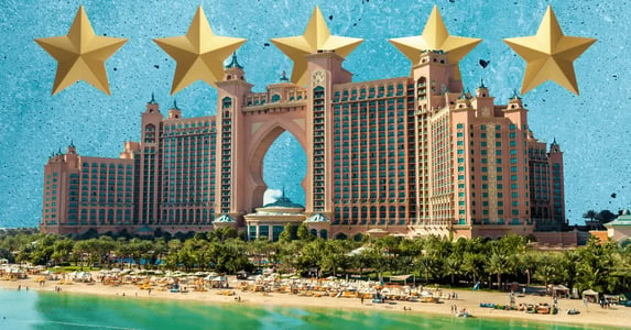 The Atlantis hotel on a blue background with five gold stars.